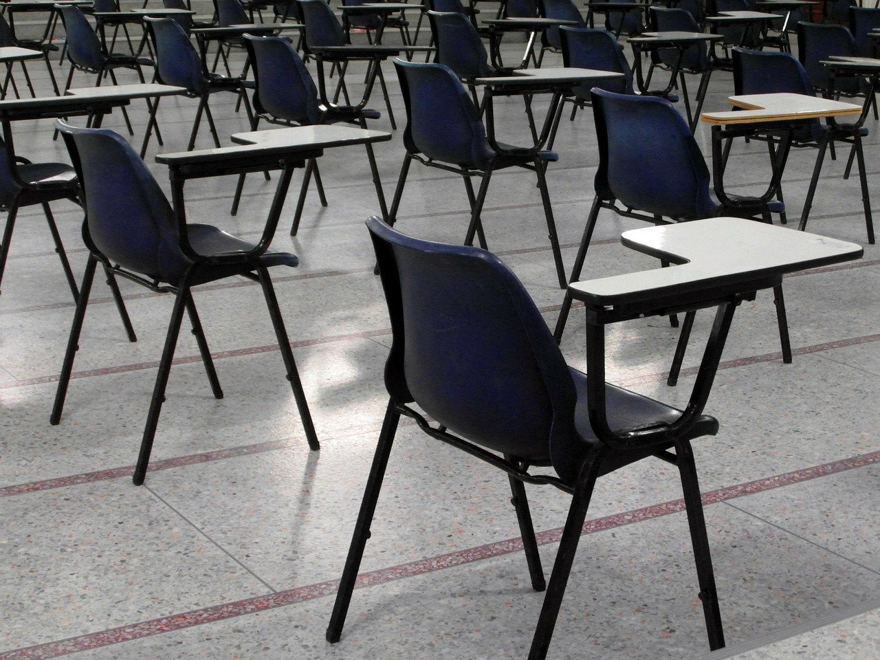 empty school hall with chairs and desks