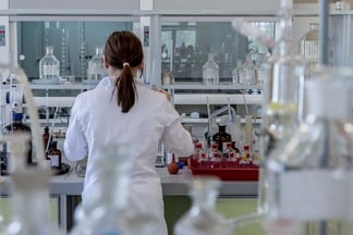 lady in white lab coat working in a lab