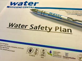 pieces of paper on a table with documents by 'water hygiene centre'