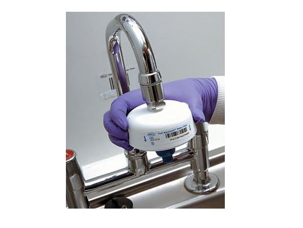 point of view attached to a tap being held by a hand with a purple rubber glove on