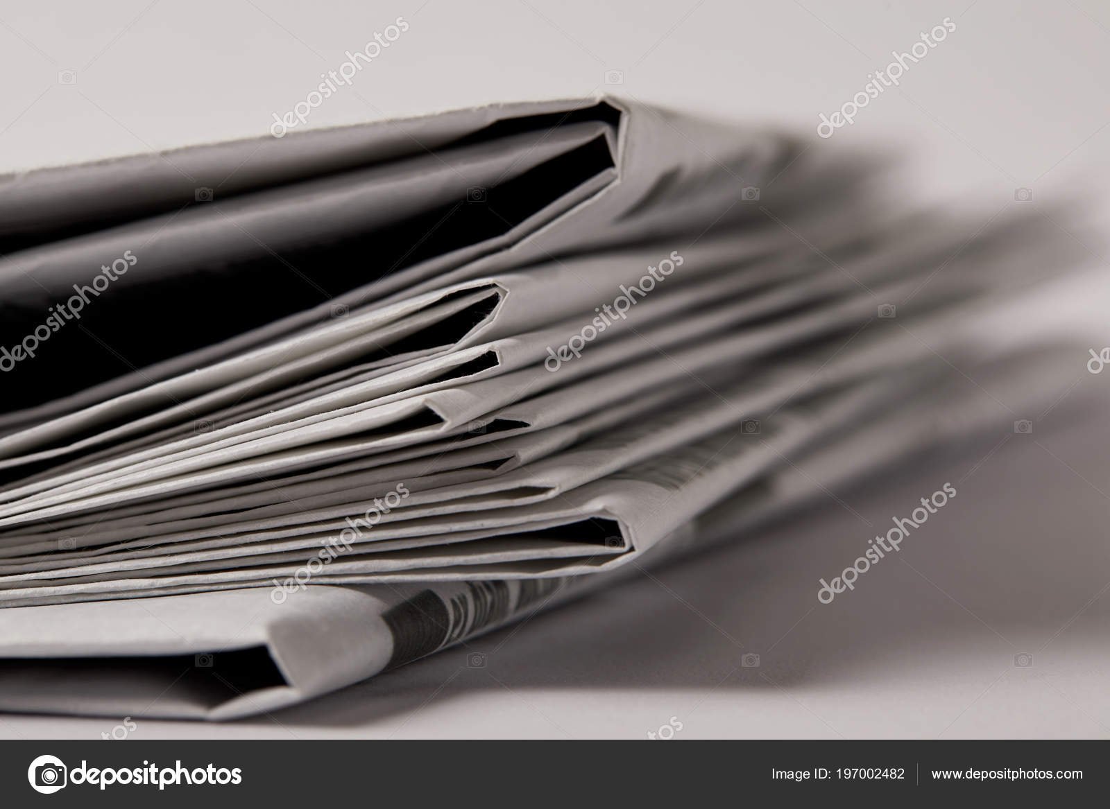 depositphotos_197002482-stock-photo-close-pile-newspapers-selective-focus