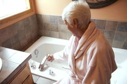 old women turning a tap