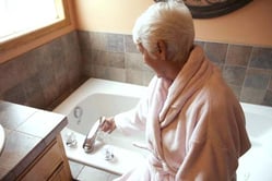 old women turning a tap