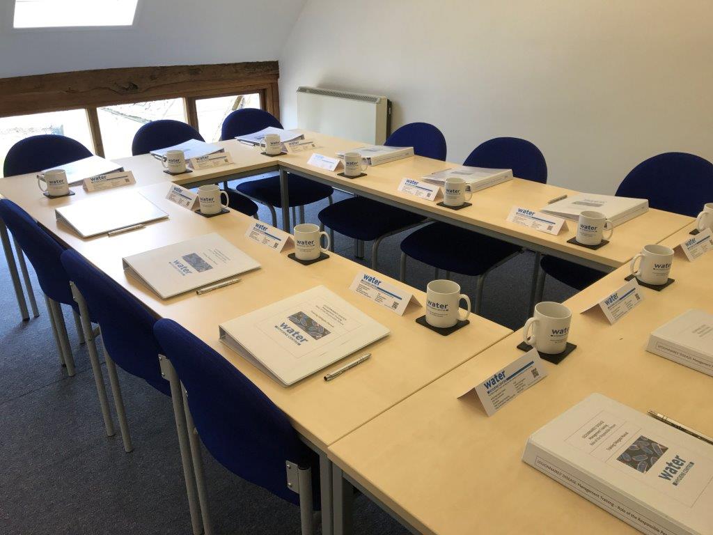meeting room with training folders and white mugs
